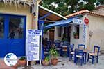 Blauwe tafeltjes and stoelen near een echte souvlakitent in Skala Eressos - Photo GreeceGuide.co.uk